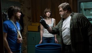 10 Cloverfield Lane Emmett Michelle and Howard all stand around the barrel