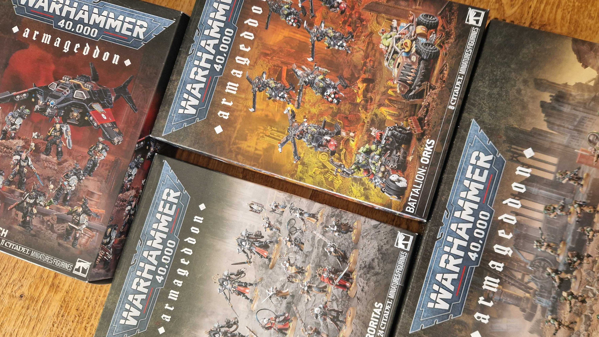 Warhammer 40,000 Armageddon Battalion boxes laid out on a wooden table