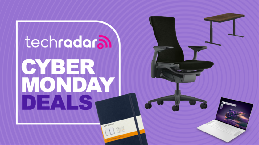 A notebook, standing desk, office chair, and laptop on a purple background next to a TechRadar badge reading &#039;Cyber Monday deals&#039;