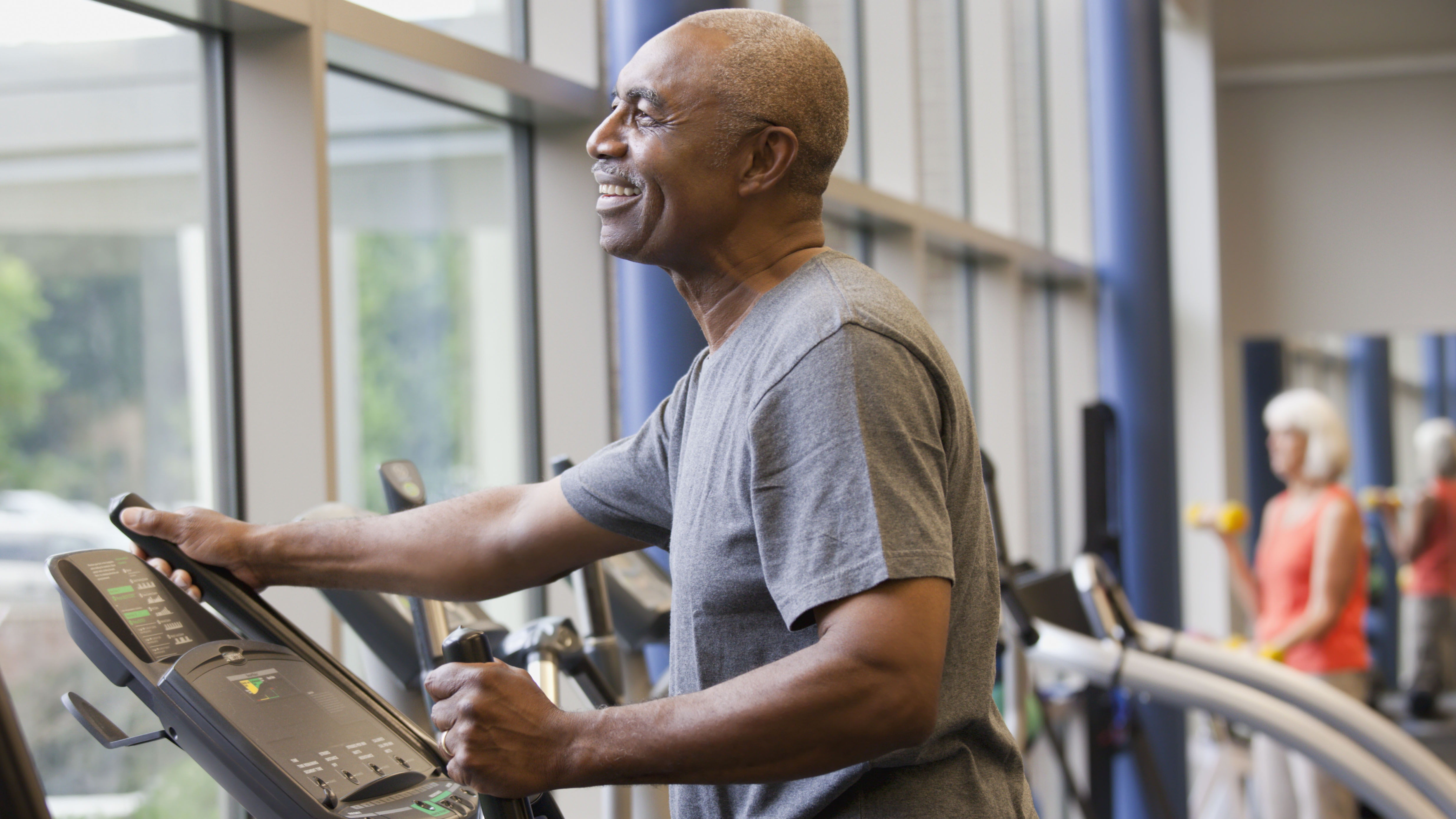 Man working out on elliptical machine
