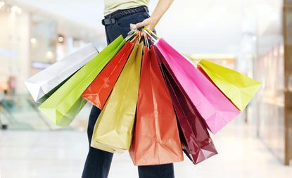 A woman holding colorful shopping bags