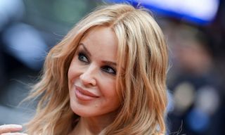 Kylie Minogue wears straight-leg jeans and heeled boots - the best duo for smart-casual styling this autumn