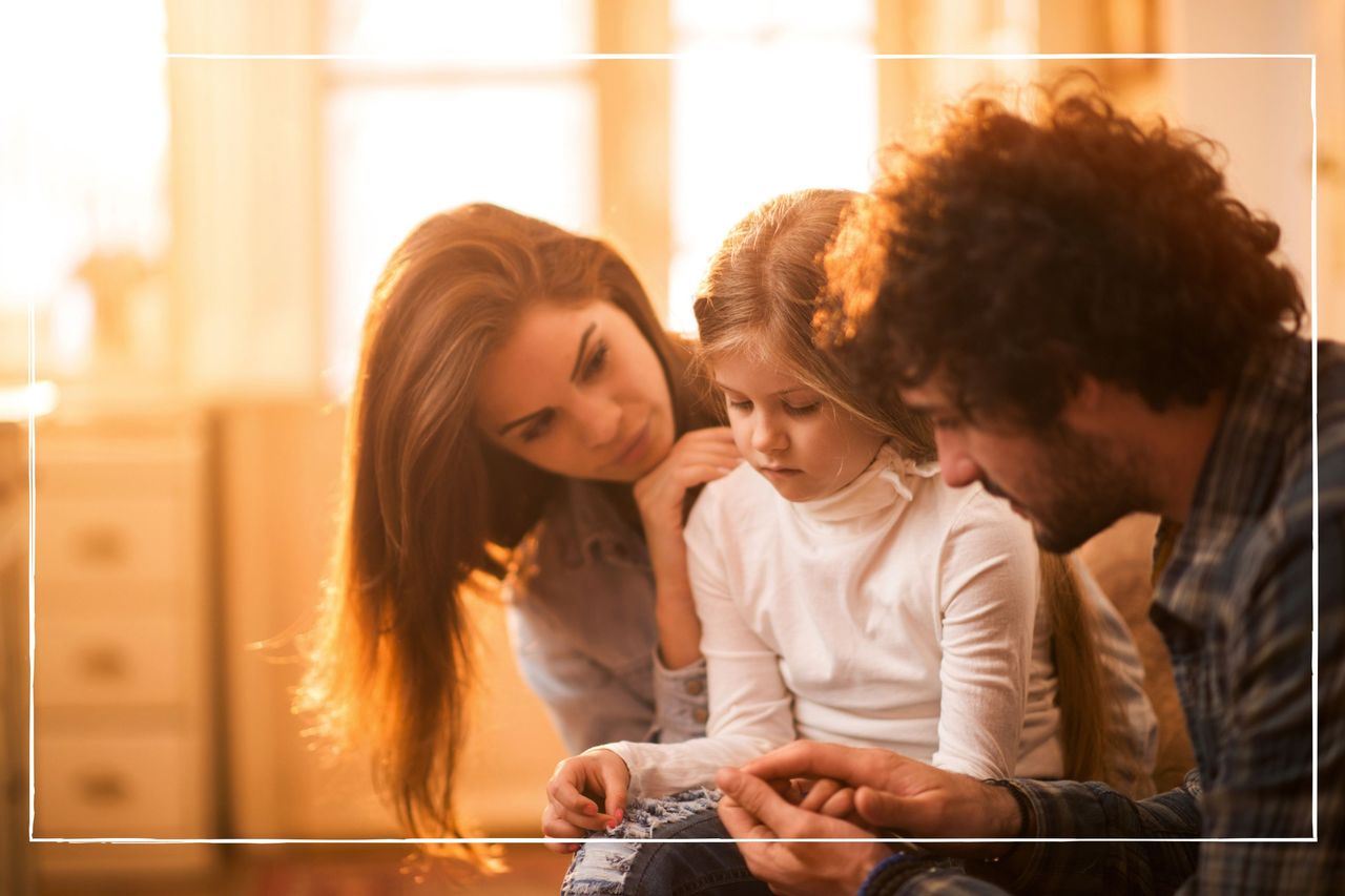 Parents consoling sad child