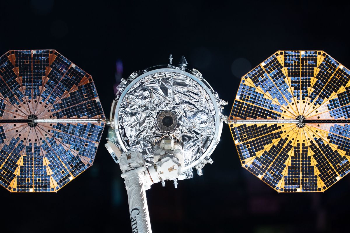 Northrop Grumman&#039;s Cygnus NG-13 cargo resupply spacecraft, with its shiny, cymbal-shaped solar arrays, is pictured in the grasp of the Canadarm2 robot arm on the International Space Station just before the vessel&#039;s departure on May 11, 2020. The NG-14 cargo ship will launch to the space station on Sept. 29, 2020.