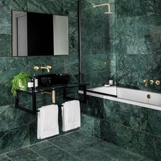 bathroom with green marble wall and bathtub