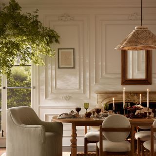 A white and red pendant light hanging over a dining table