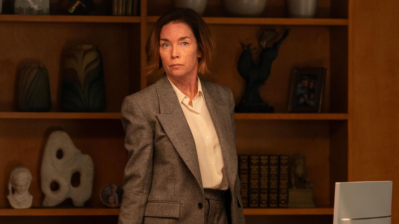 julianne nicholson as sinatra wearing a grey suit standing in an office in the paradise season 1 finale