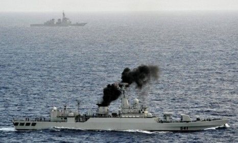 A Chinese warship (front) and Japanese vessel sail near southern Japan: Chinese ships have reportedly harassed neighboring countries during patrol.