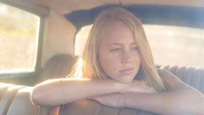 woman in a car looking contemplative
