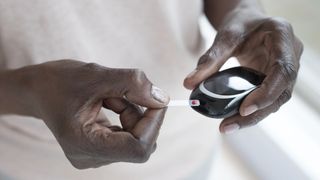 Best glucose meters: A man uses a glucometer to test his blood sugar levels