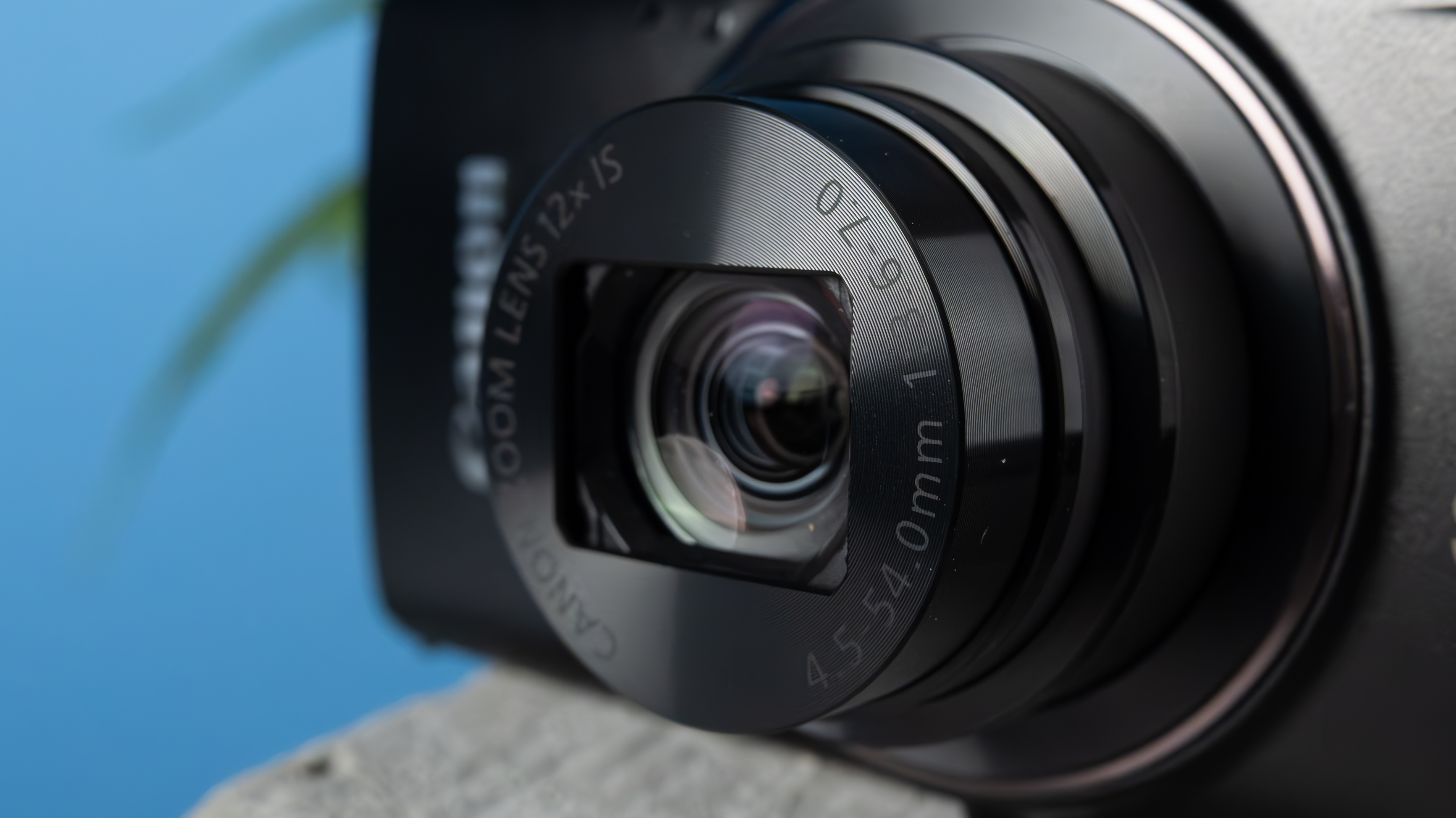 A black Canon PowerShot Elph 360 HS A or Canon PowerShot IXUS 285 HS A compact camera