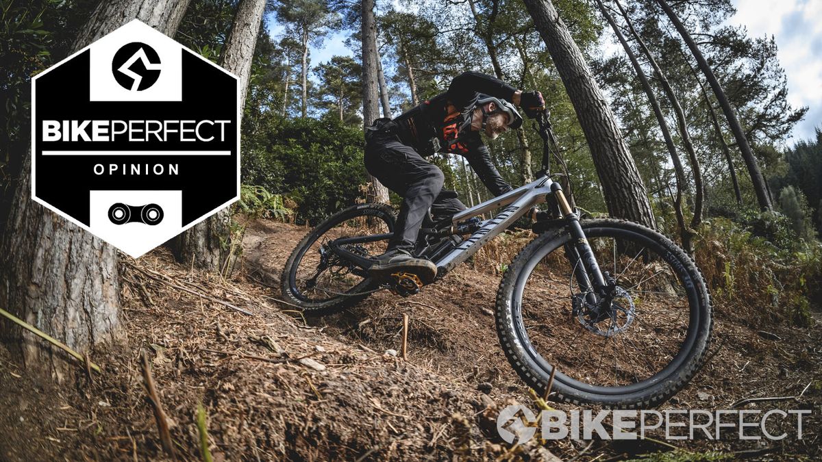 Guy Kesteven descending a steep hill on the Canyon Spectral CFR, with a BikePerfect &#039;Opinion&#039; badge on the left