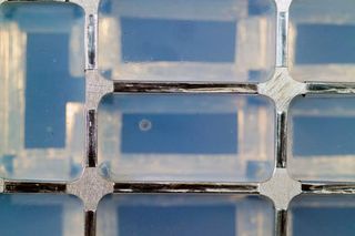 Closeup view of a cometary impact (center) into aerogel was inspected by scientists at a laboratory at the Johnson Space Center hours after the Stardust Sample Return Canister was delivered to the Johnson Space Center from the spacecraft's landing site in Utah.