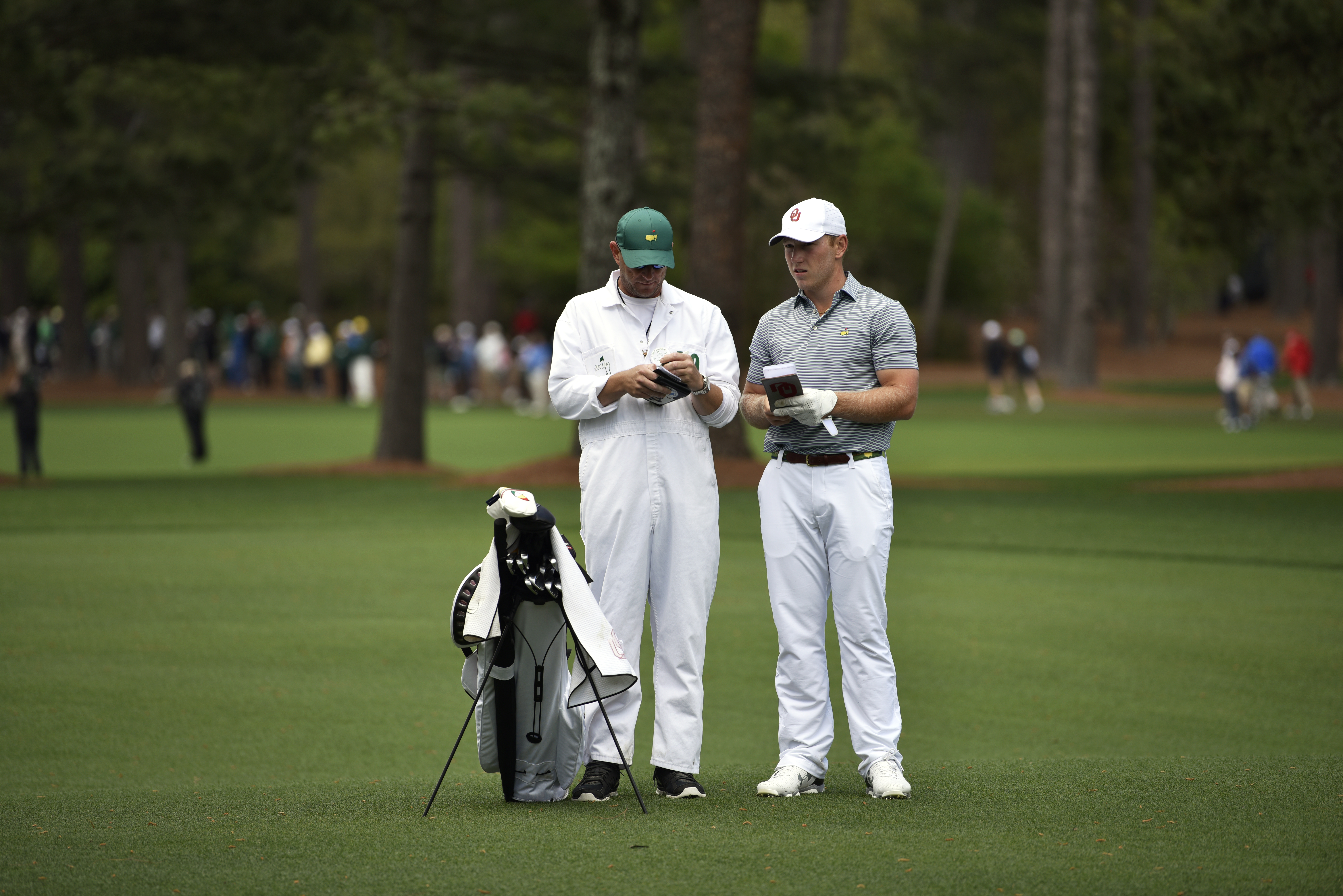 Brad Dalke and his caddie Chris Beckner mark yardage during the first round of the Masters at Augusta National Golf Club