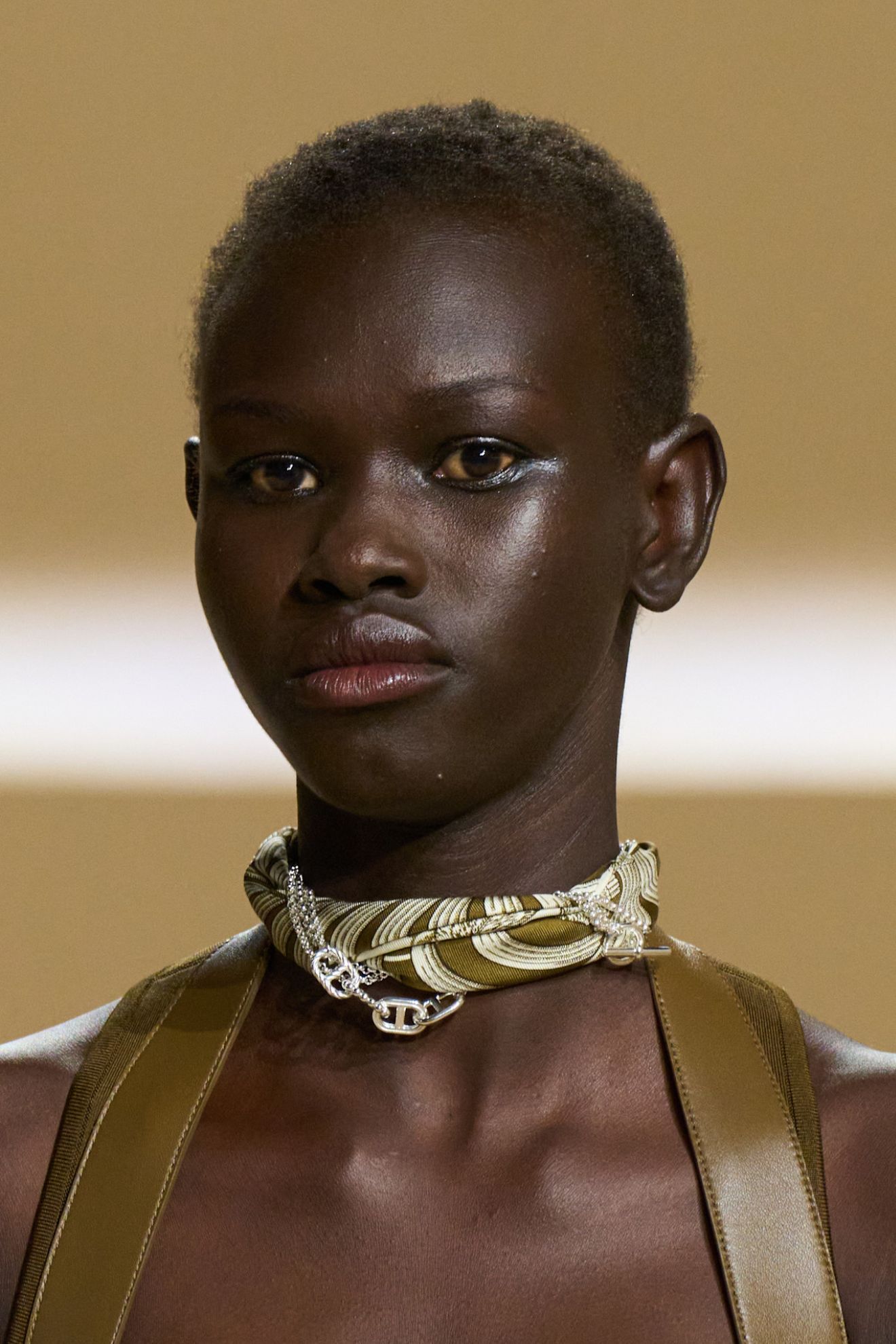 A model at the SS26 Paris Hermès show with glowy skin and a glossy lip
