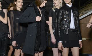 Close up shot showing outfit details of a group of models including decorative leather jacket