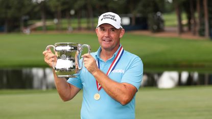 Padraig Harrington holds up the US Senior Open trophy after winning at Broadmoor Golf Club in 2025