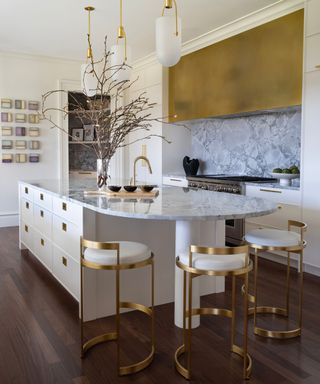 White kitchen with marble and gold accents