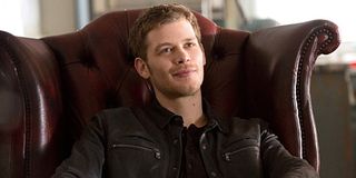 The Originals Klaus Mikaelson smiles while seated in chair The CW