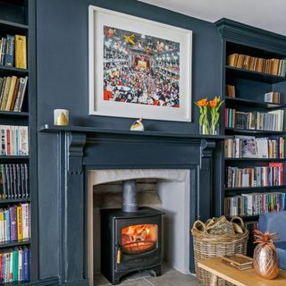 room with open book shelve fireplace and grey wall