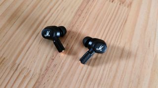 Marshall Motif II ANC review: earbuds on wooden table