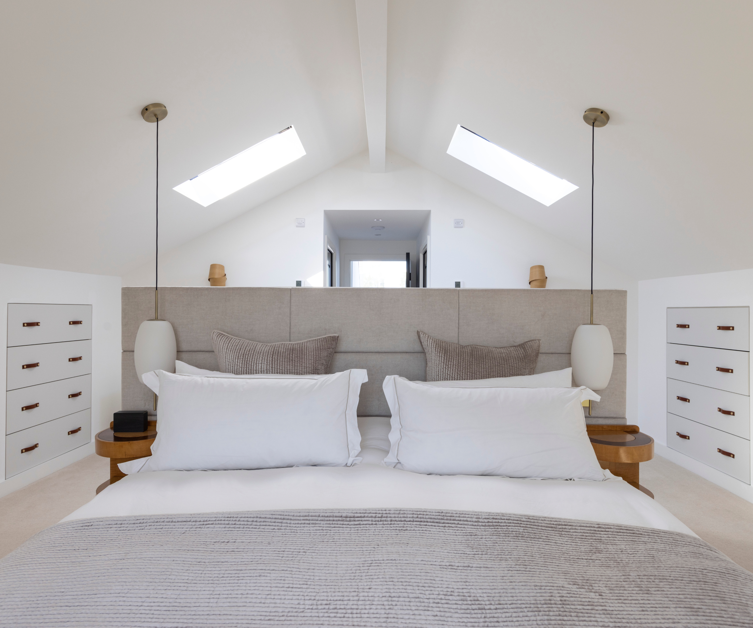 loft bedroom with drawers built into side walls