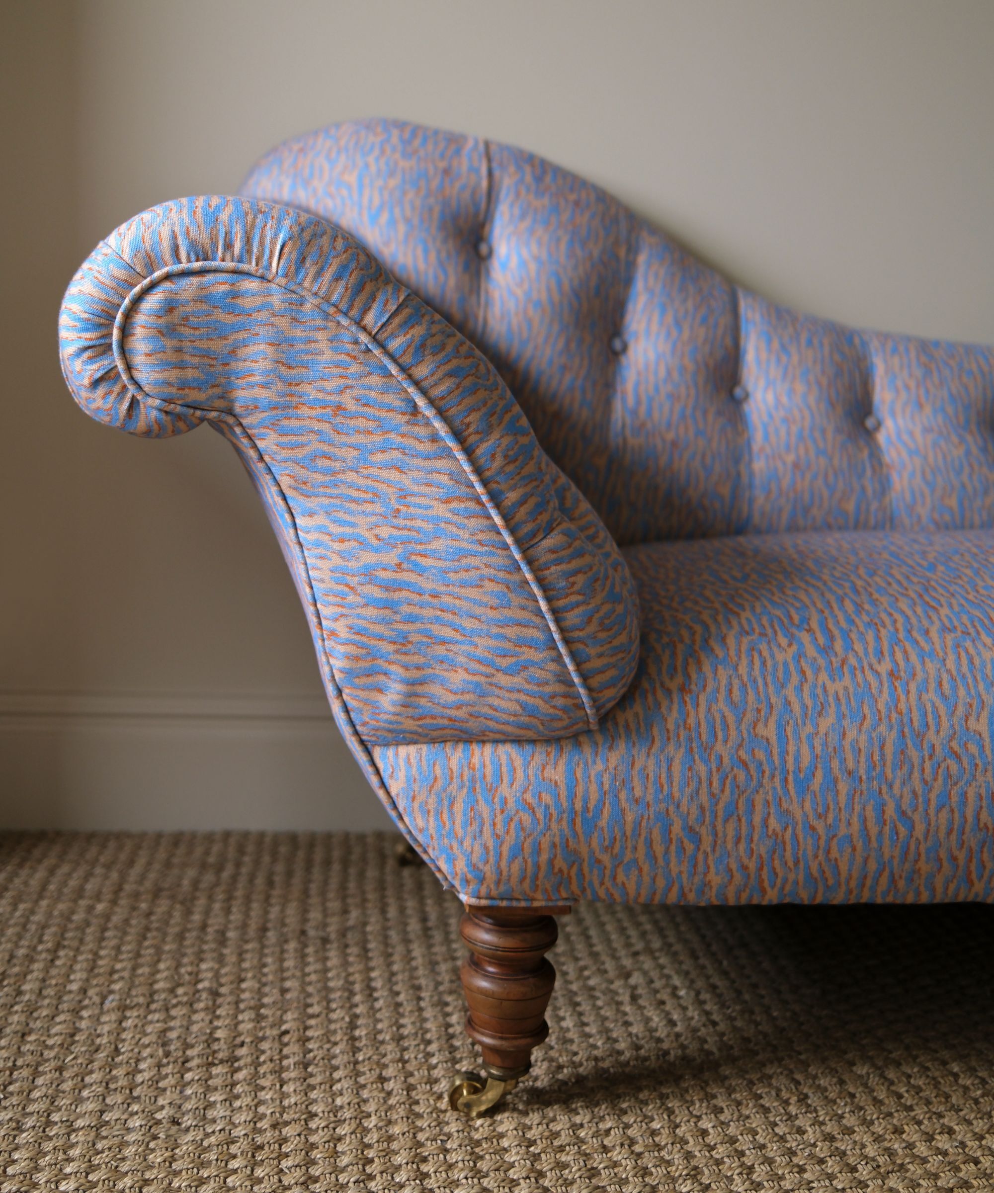 Upholstered sofa in blue and gold animal print fabric