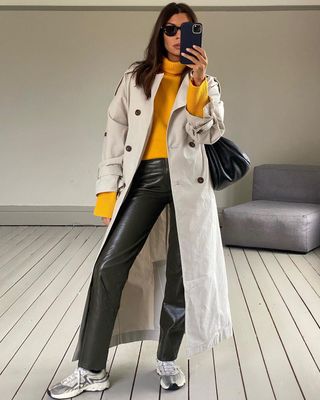 Leather trousers with white trainers and trench