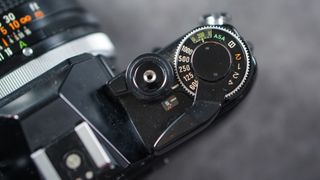 The dials on a Canon AE-1 SLR film camera