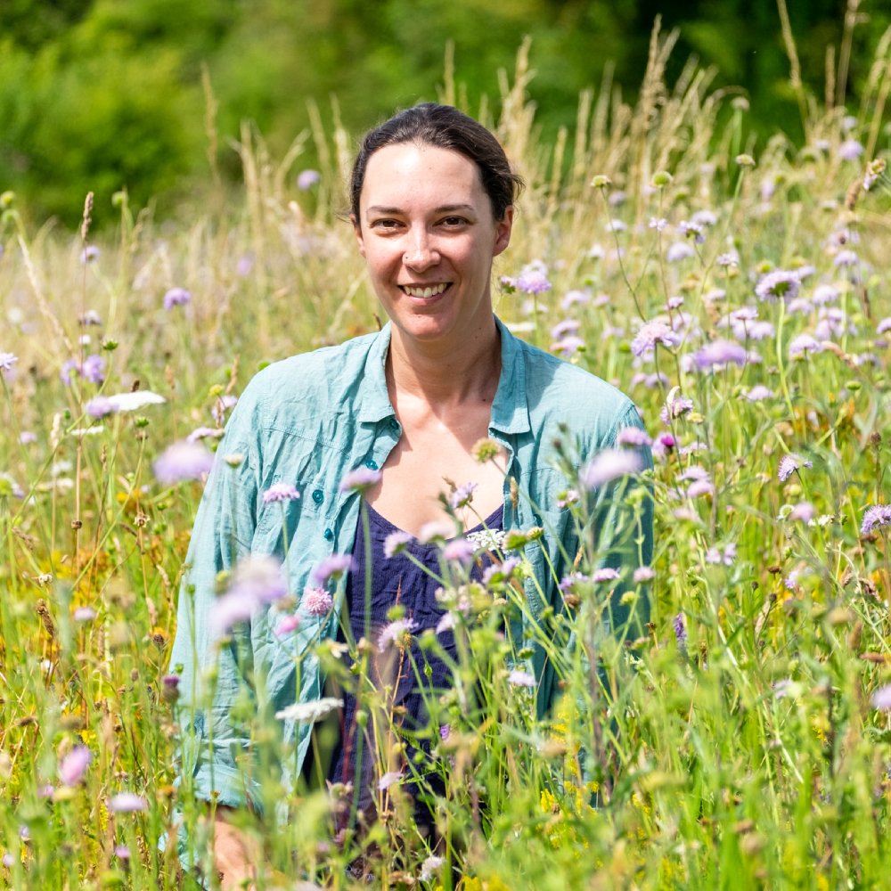 female stood in wildflower garden
