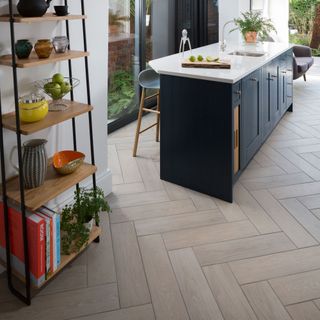kitchen with ladder shelving, island and herringbone flooring