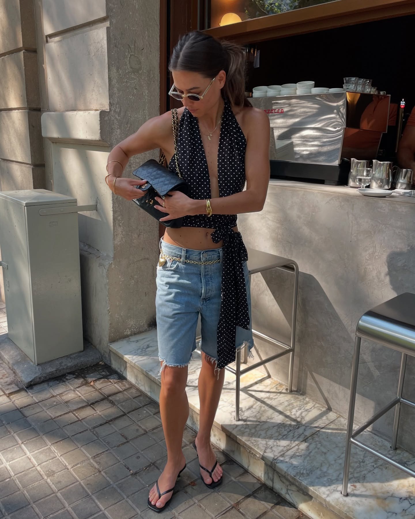 Woman in a polka-dot top and Bermuda jeans