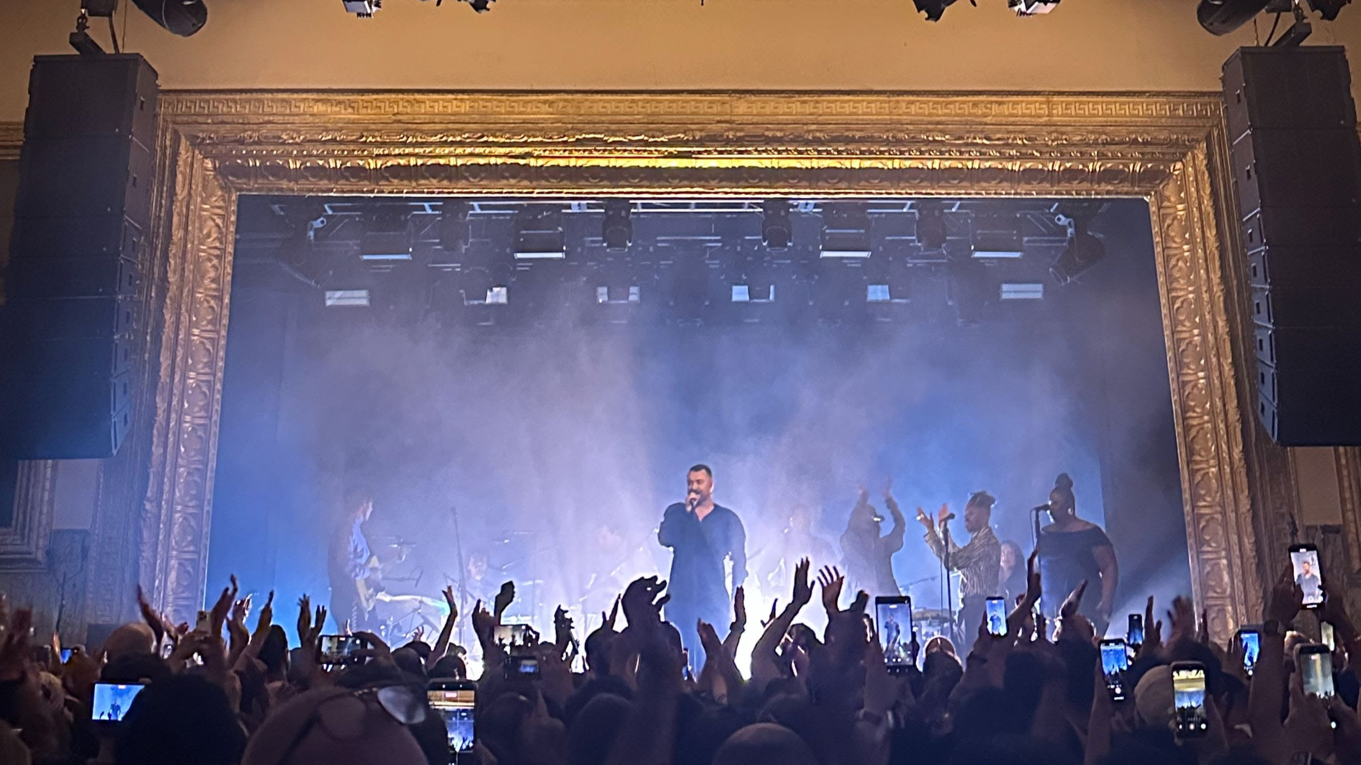 The stage at the historic Warsaw in Brooklyn with a rocker singer to the crowd.