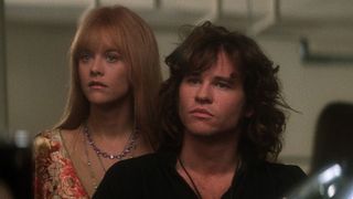 Meg Ryan and Val Kilmer star as pamela and jim morrison wearing 70s like clothes and hair in 'The Doors'