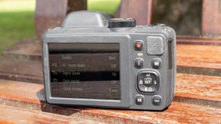 Kodak PixPro AZ405 digital camera in black on a wooden slatted table