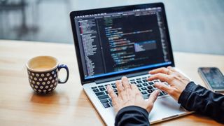 Best coding courses online: Person coding on laptop