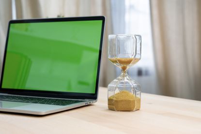 photo illustration of laptop and sandglass