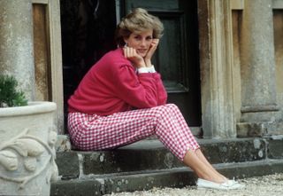 Diana, Princess of Wales sitting on a step at her home, Highgrove House, in Doughton, Gloucestershire