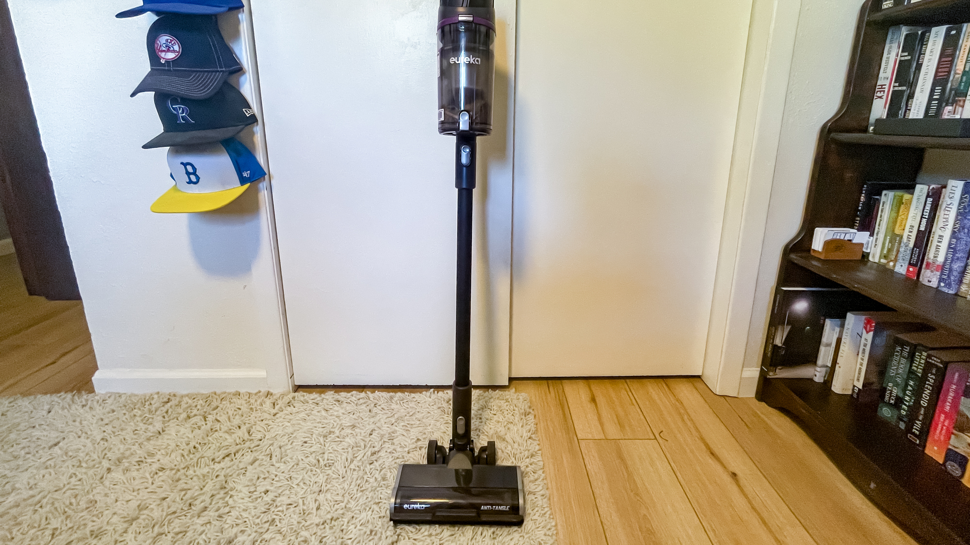 Eureka ReactiSense 440 Smart Cordless Vacuum against wall in room