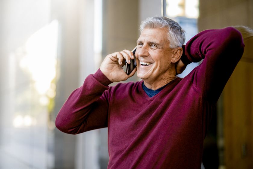 Smiling businessman talking on mobile phone