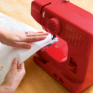sewing machine with red color and cotton fabric