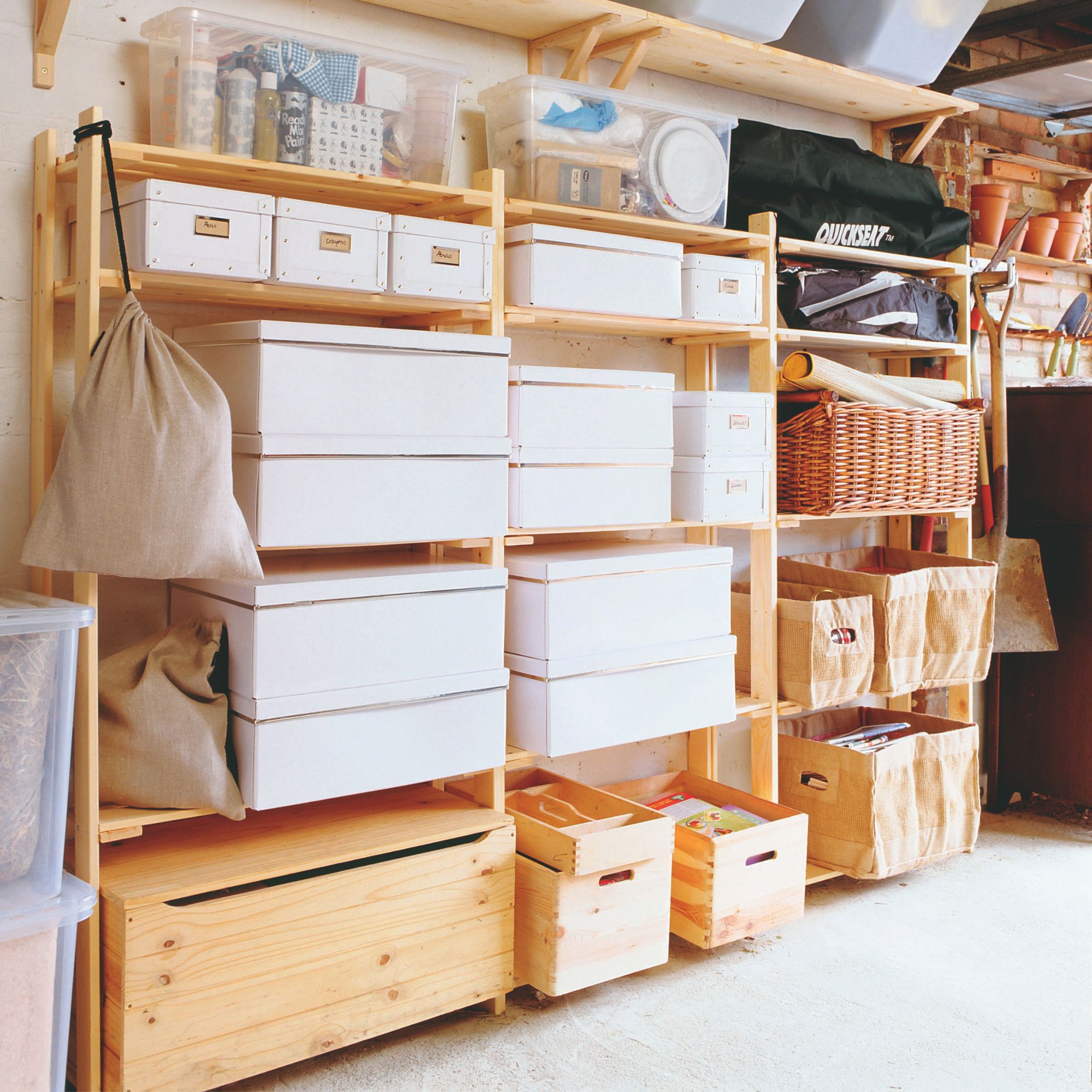 Garage with wooden shelving units stacked full of boxes