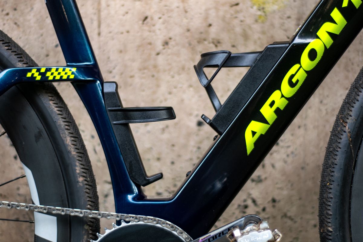 An Argon 18 Anti Matter gravel bike leaning against a concrete wall.