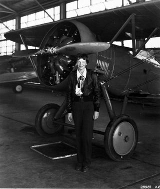 Amelia Earhart in front of plane