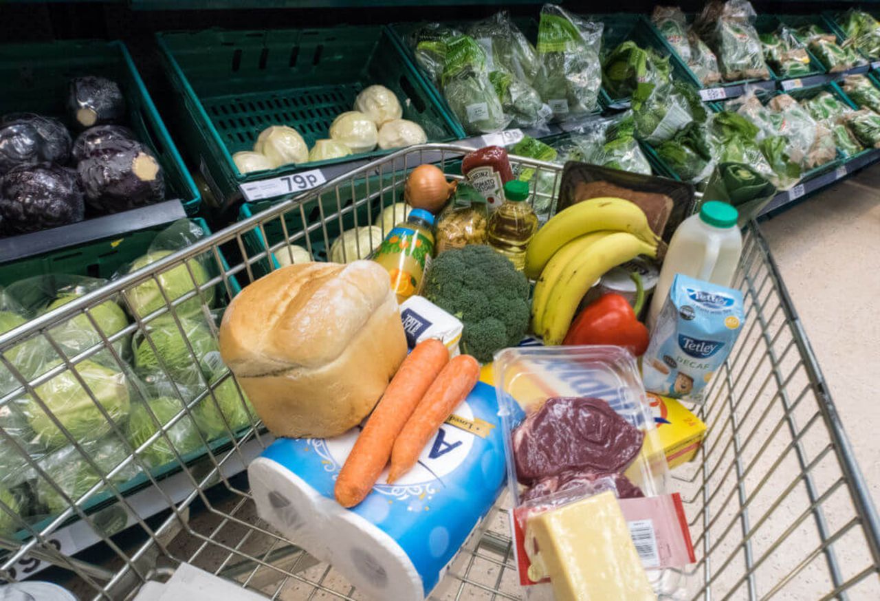 A supermarket trolly with groceries in it