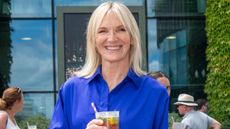 Jo Whiley holding Pimm's, an Official Partner of Wimbledon, at All England Lawn Tennis and Croquet Club on July 9, 2025