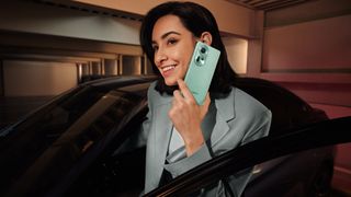 The Oppo Reno 11 5G being used by a woman entering a car