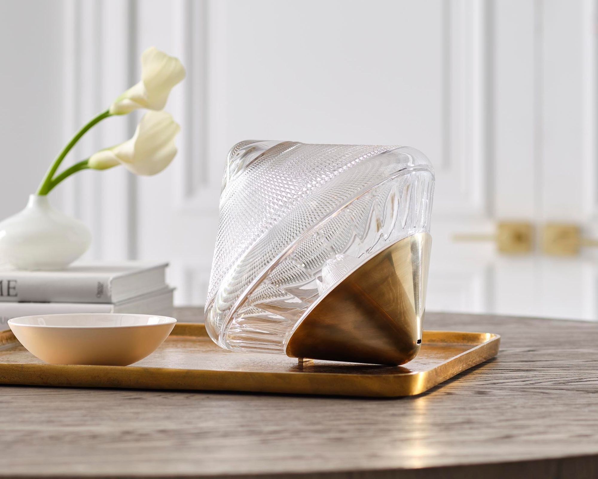 Glass portable light with a brushed brass point