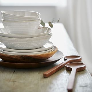 grey stoneware bowls and acacia dishes