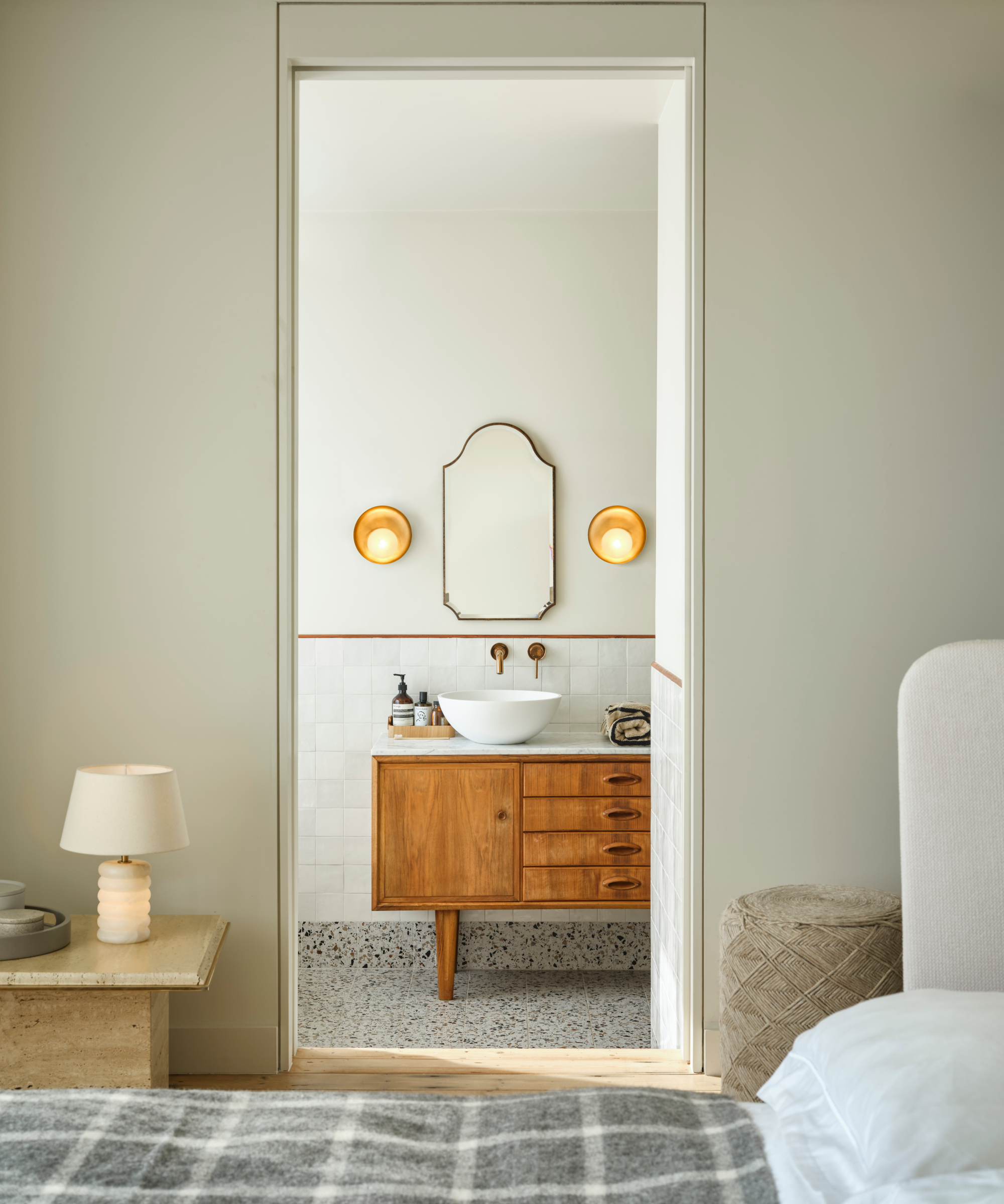 view into ensuite with wall lights above sink